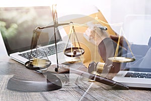 Justice and law concept.Male judge in a courtroom with the gavel, working with, computer and docking keyboard, eyeglasses, on