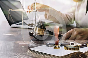 Justice and law concept.Male judge in a courtroom with the gavel, working with, computer and docking keyboard, eyeglasses, on