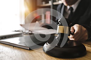 Justice and law concept.Male judge in a courtroom with the gavel,working with,digital tablet