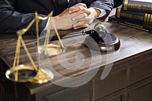 Justice and law concept.Male judge in a courtroom working on wood table with documents., attorney court judge justice gavel legal