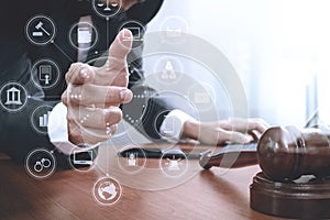 justice and law concept.Male lawyer in office with the gavel,working with smart phone,digital tablet computer docking