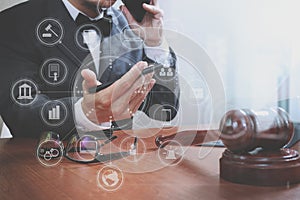 justice and law concept.Male lawyer in office with the gavel,working with smart phone,digital tablet computer docking