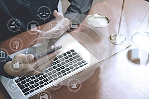 justice and law concept.Male lawyer in office with the gavel,working with smart phone,digital tablet computer docking