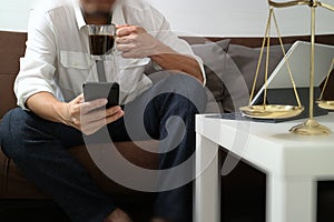 Justice and Law context.Male lawyer hand sitting on sofa and wor