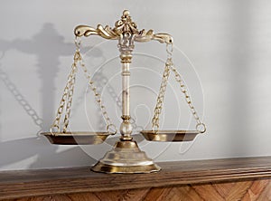 Justice Scale On Wooden Shelf Surface photo