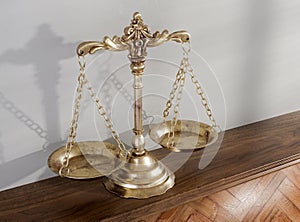 Justice Scale On Wooden Shelf Surface photo