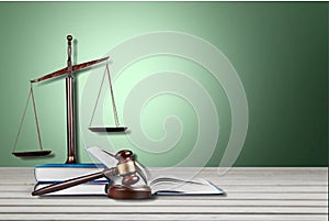 Justice Scales and books and gavel o wooden table