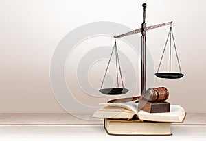 Justice Scales, gavel and books on light