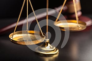 Justice Scales and wooden gavel on wooden table