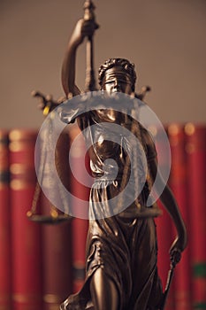 Justice statue holding a balance and sword for law and justice concept photo