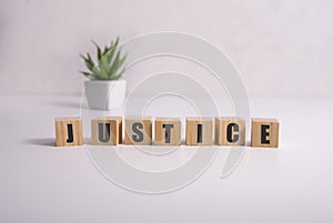 JUSTICE word made with building blocks on white