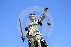 Justitia Lady Justice sculpture on the Roemerberg square in Frankfurt photo