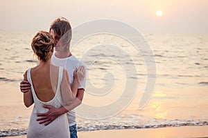 Justmarried couple running on a sandy beach