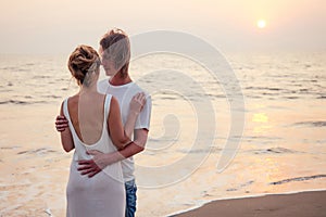 Justmarried couple running on a sandy beach