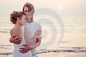 Justmarried couple running on a sandy beach