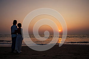 Justmarried couple running on a sandy beach