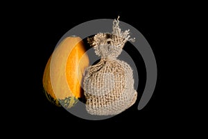 Jute bag and pumpkin on a black background