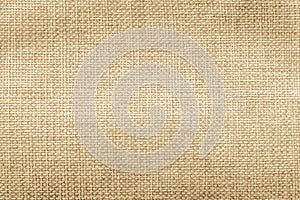 Jute hessian sackcloth natural burlap texture background in yellow gold brown color