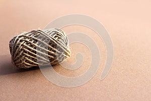 Jute rope roll on brown background. Ball of twine