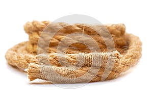 Jute rope with sealed ends rolled in coil on white background