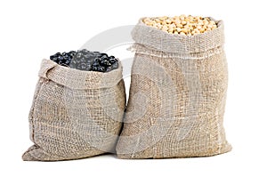 Jute sacks with soja beans and black legume photo
