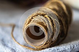 Jute string roll close up on linen fabric background