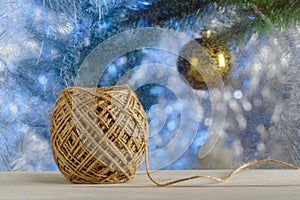 Jute twine for wrapping Christmas gifts. Sill frosty Windows. Blurred background. A rustic style.