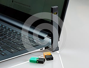 JUUL nicotine dispenser beng charged in laptop with flavor pods