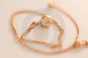 18K golden ball necklace on white closeup
