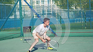 4K. The guy is a tennis player with a racket and a ball, the man is preparing to hit the ball with a racket