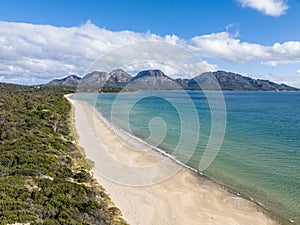 4k high angle aerial drone view of Muirs Beach near Coles Bay, Tasmania photo