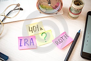 401k ira roth on pieces of colorful paper dollars on table. Pension concept. Retirement plans