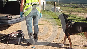 K9 drug police dog with policeman in operation for suspected drug suitcase