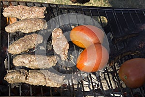 Kabobs and Tomatoes on a charcoal grill