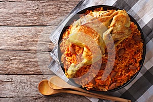 Kabsa of chicken with rice and vegetables on the table. Horizontal top view