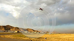 Boeing 737 passenger aircraft departing from Hamid Karzai International Airport in Kabul during sunset.