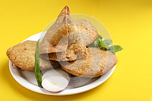 Kachori and potato samosa with green chilly in plate. famous spicy snack in india