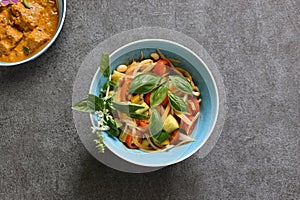 Kachumber in a bowl and curry isolated on a gray background