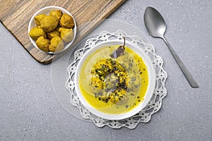 Kadhi Pakora, a punjabi cuisine made with fritters dipped in curd base curry with gram flour and spices