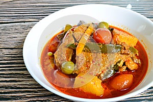 Kaeng Pled Ped Yang Roasted Duck in Red Curry with tomato,  pineapple and chili peppers in red curry, Thai style.
