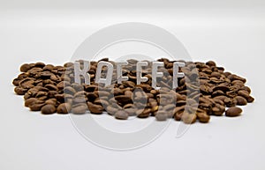 `Kaffee` written as wooden letters inside coffee beans isolated on white background photo