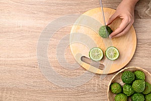 Kaffir lime cutting on wooden board, Table top view