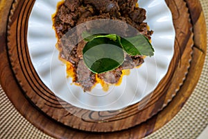 Kaffir lime leaf or Daun limau purut on Rendang Daging or beef rendang. Traditional dish usually served during Eid festival