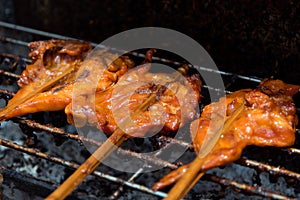 Kai yang - Thai style grilled chicken street food on the night m photo