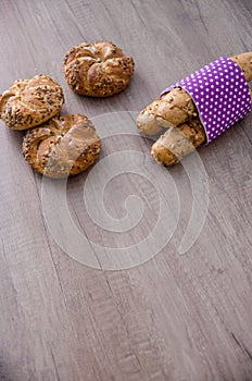 Kaiser bun and baguette on wood table. Pastry vegetarian bio food concept.