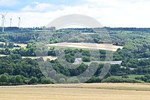 Kaisersesch, Germany - 07 26 2022: The Autobahn and wind power plants on the hill