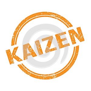 KAIZEN text written on orange grungy round stamp