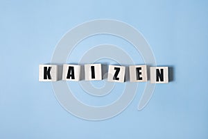 Kaizen - words from wooden blocks with letters, a Japanese business philosophy kaizen concept, white background