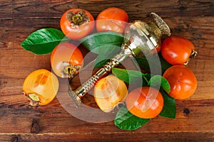 Kaki fruits composition on old wood. Oriental East still life