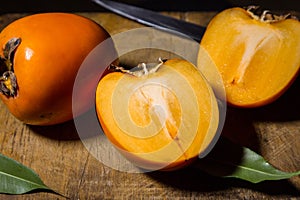 Kaki or persimmons  fruits on a old wooden background